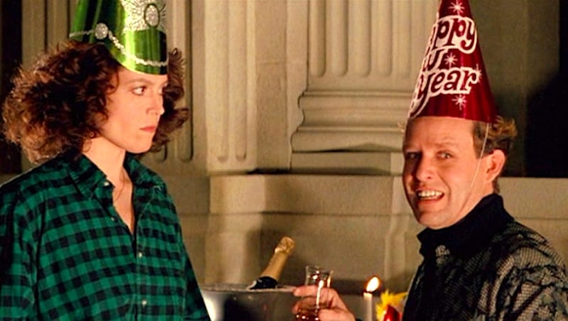 Sigourney Weaver and Peter MacNicol wearing New Year's hats in Ghostbusters 2